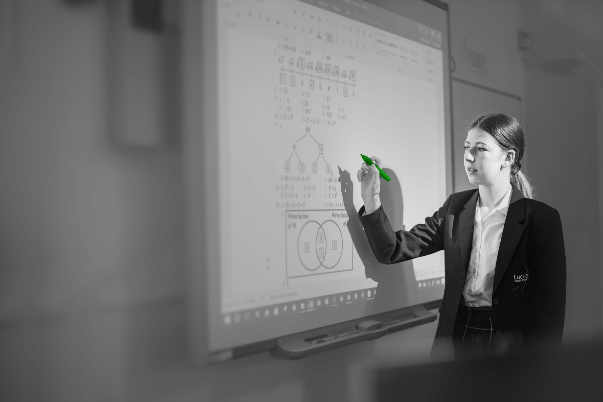 student writing on a smart board