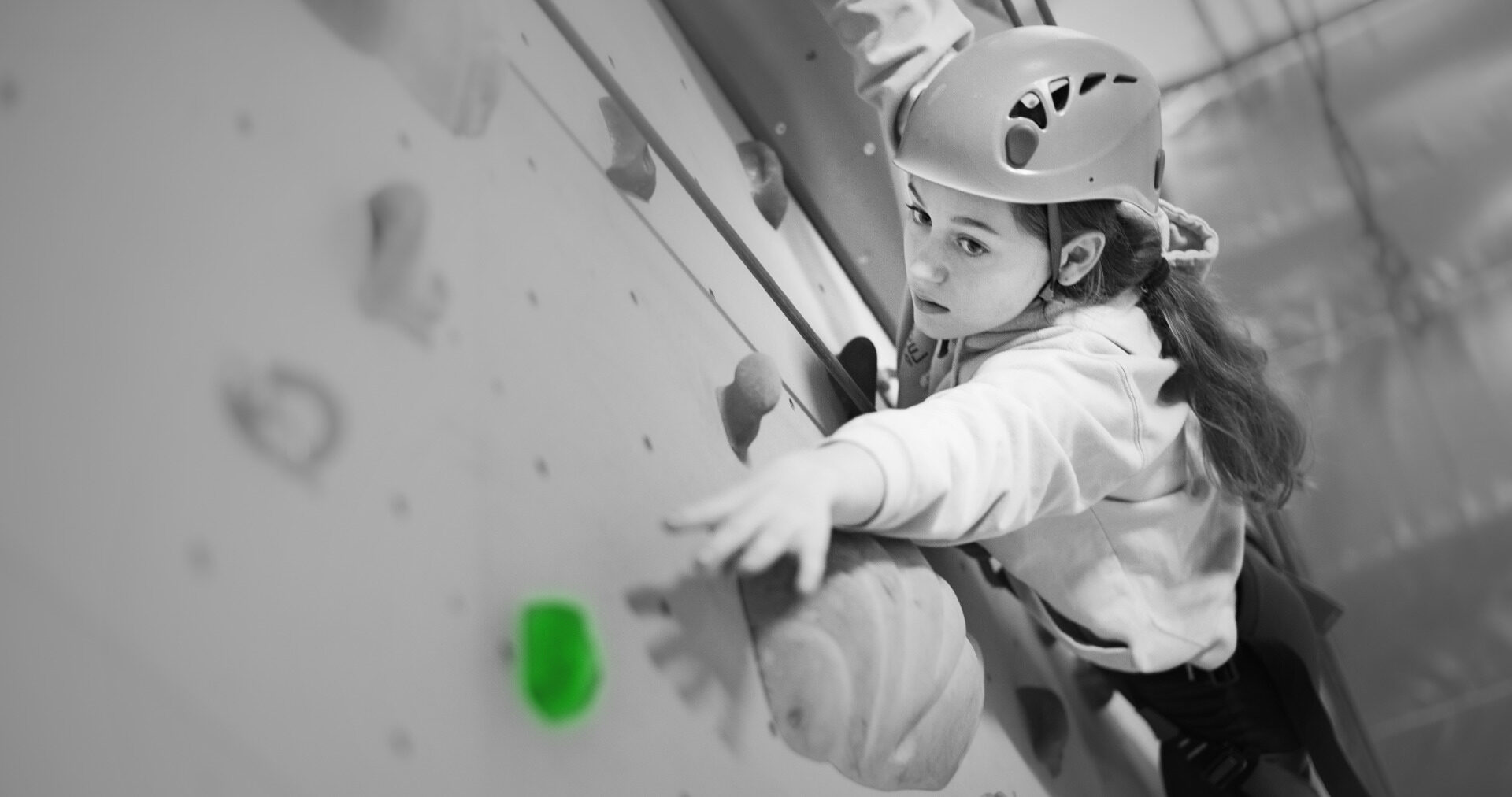 student rock climbing