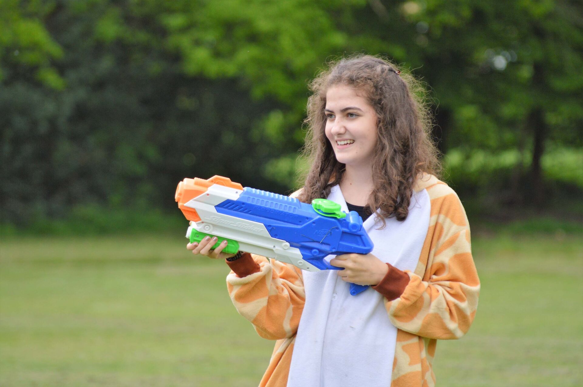 student with a water gun in her hands