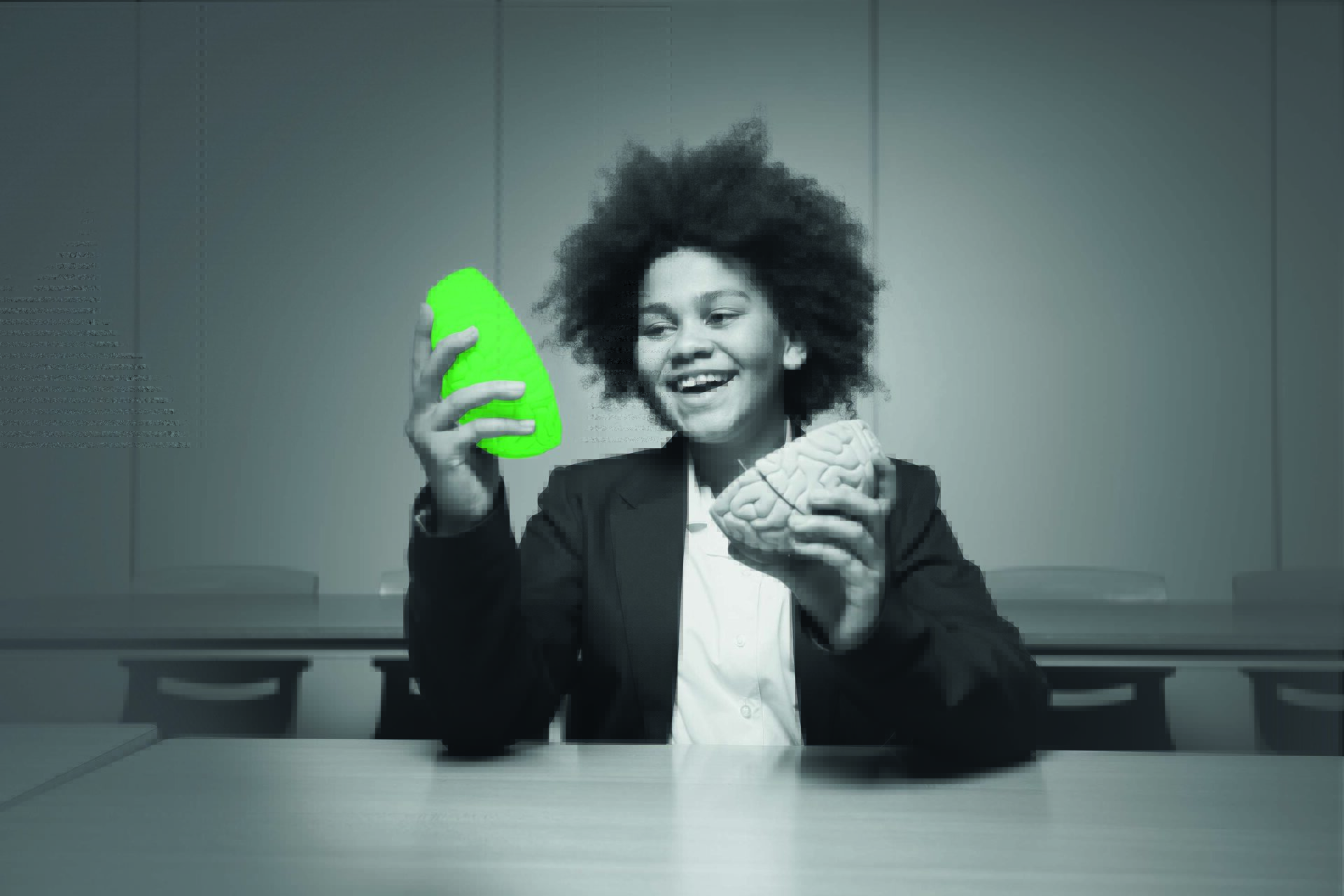 student holding a model brain