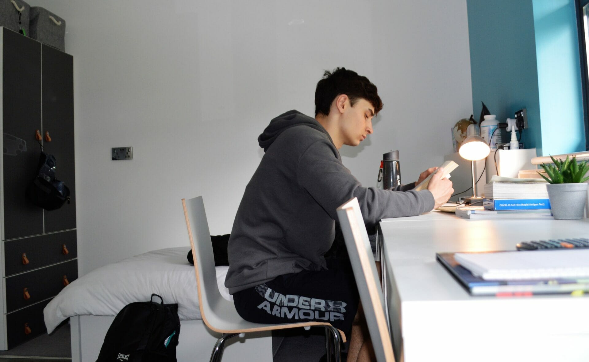 boy in his boarding room