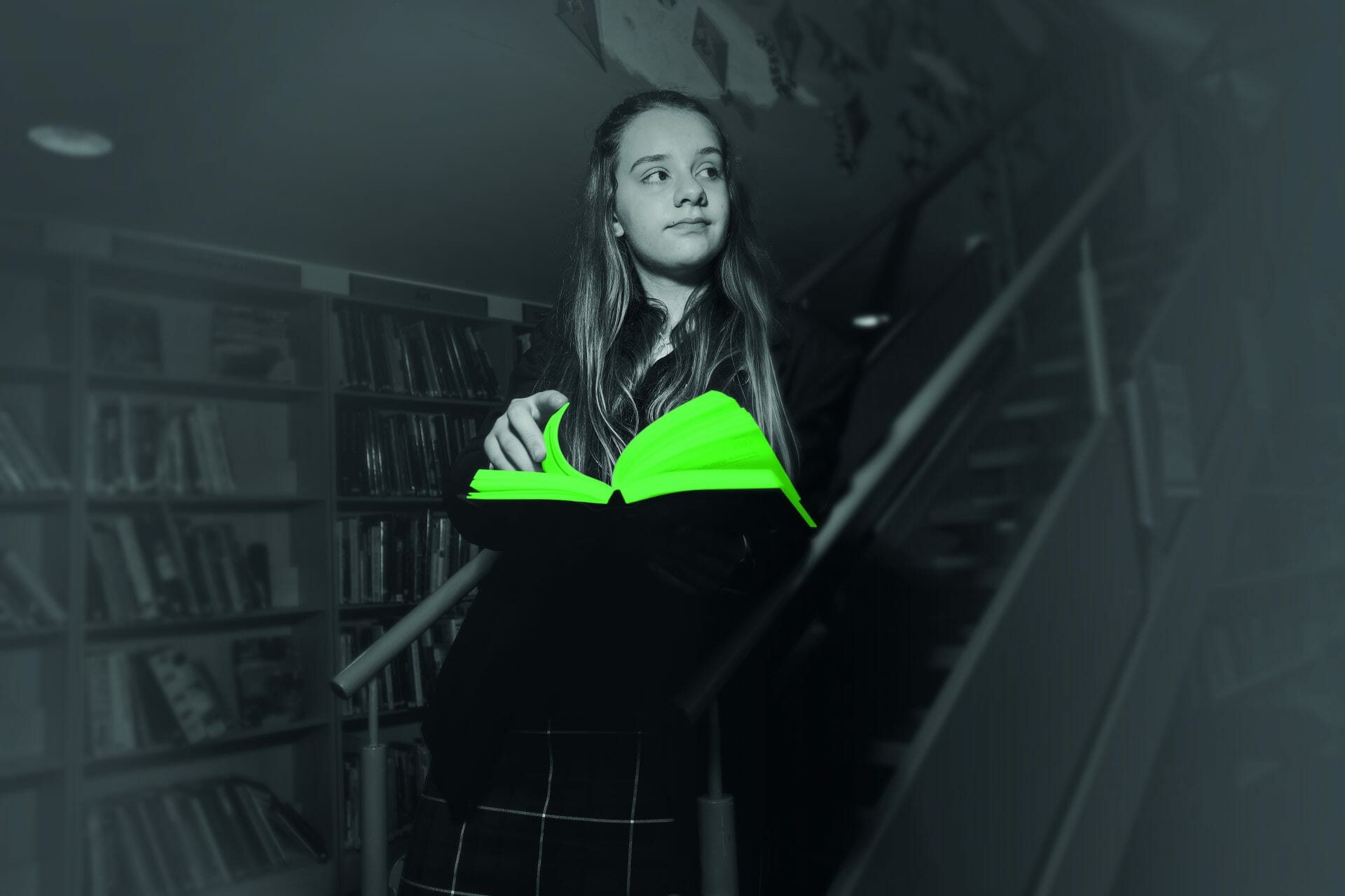 girl holding an illuminated green book