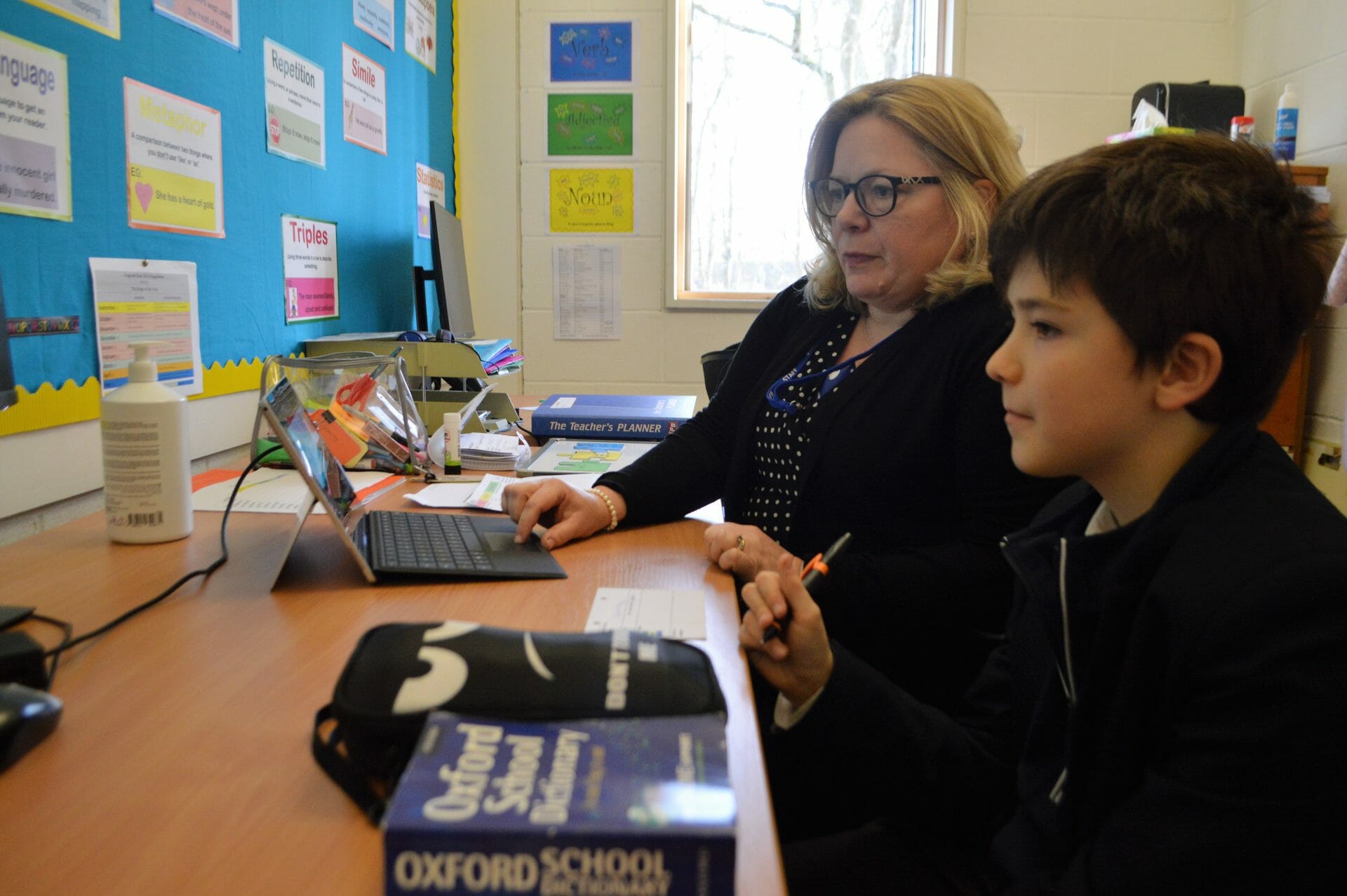 child receiving help on his work