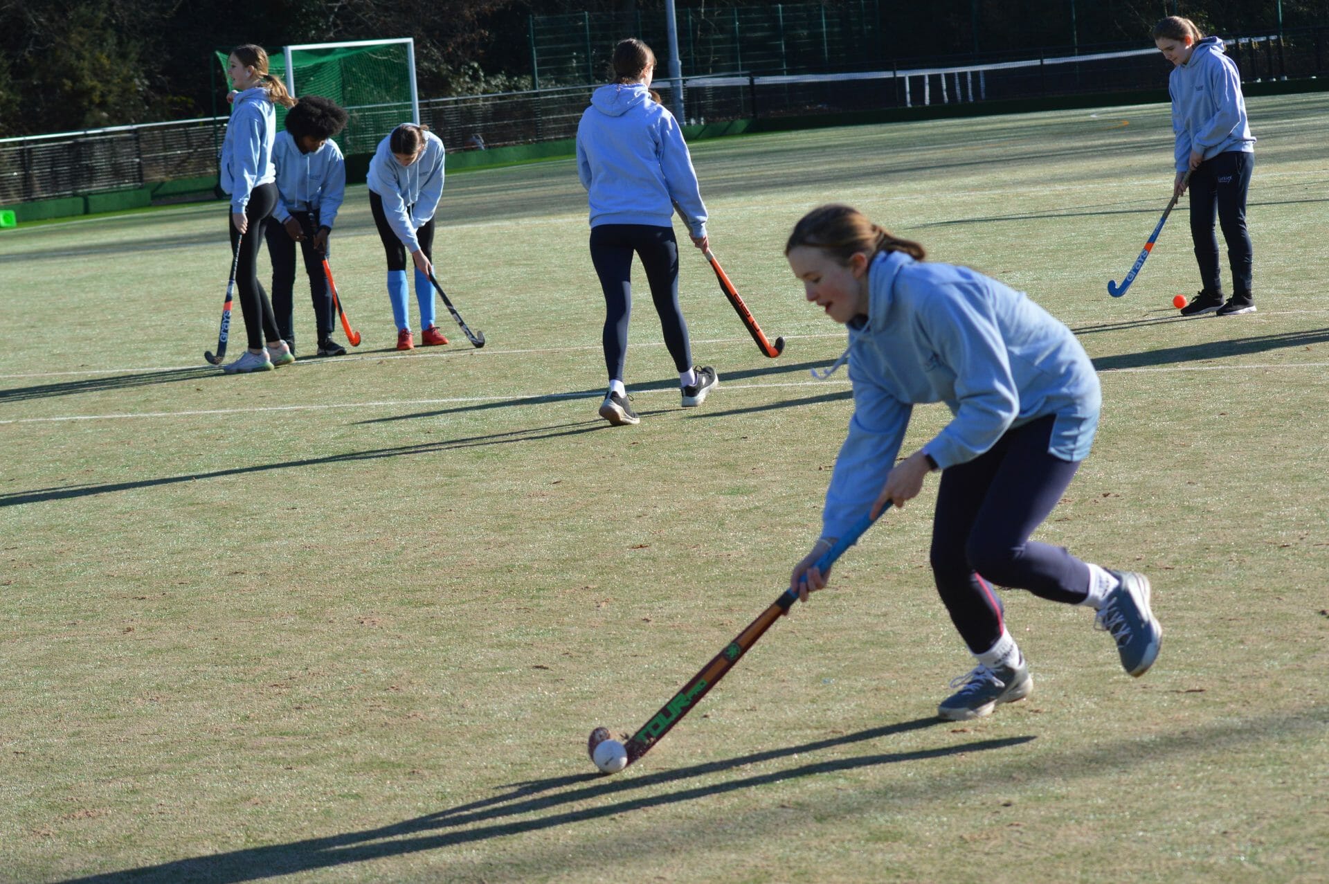 children playing hockey on a field