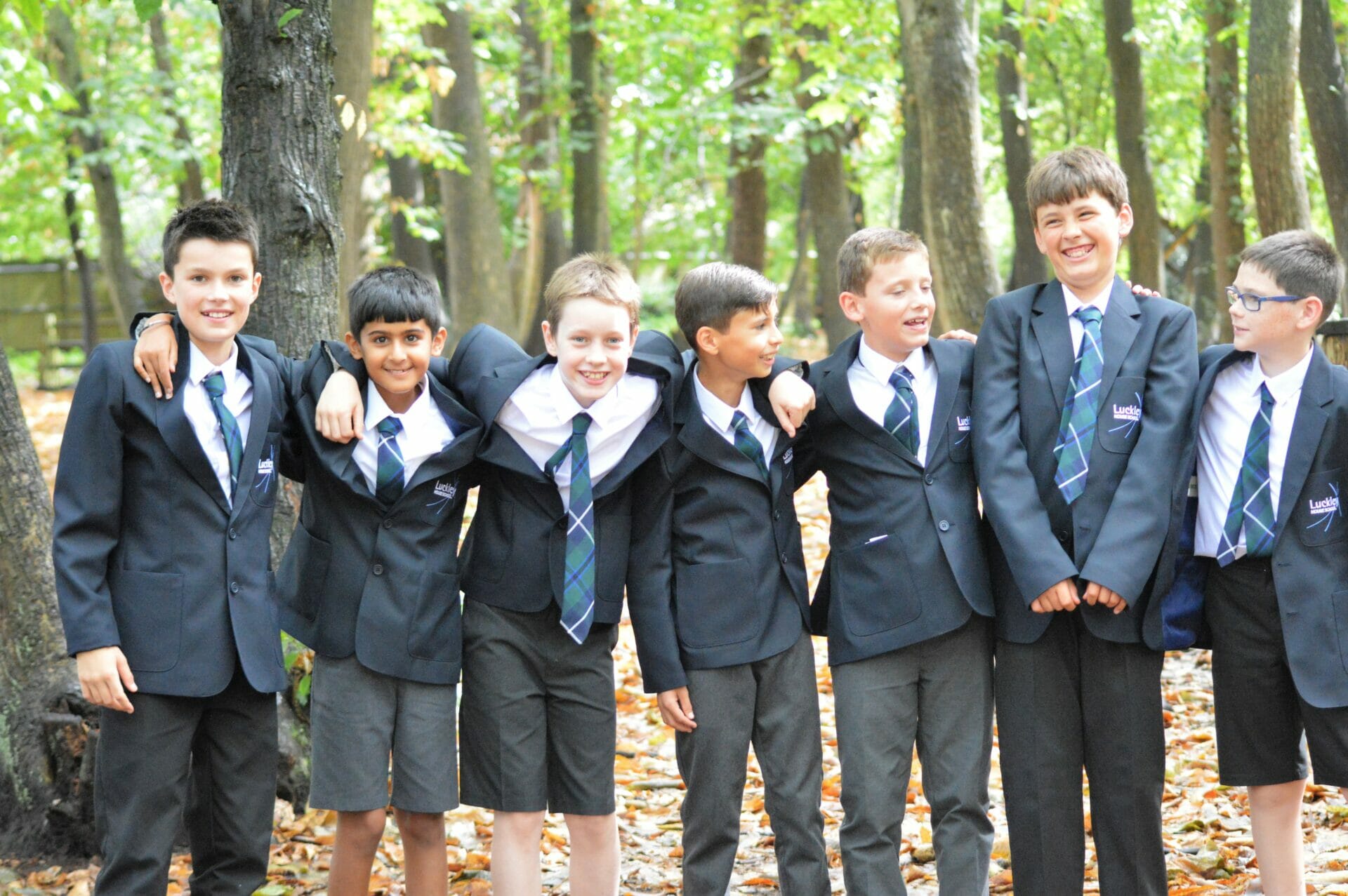 children standing with arms over one another