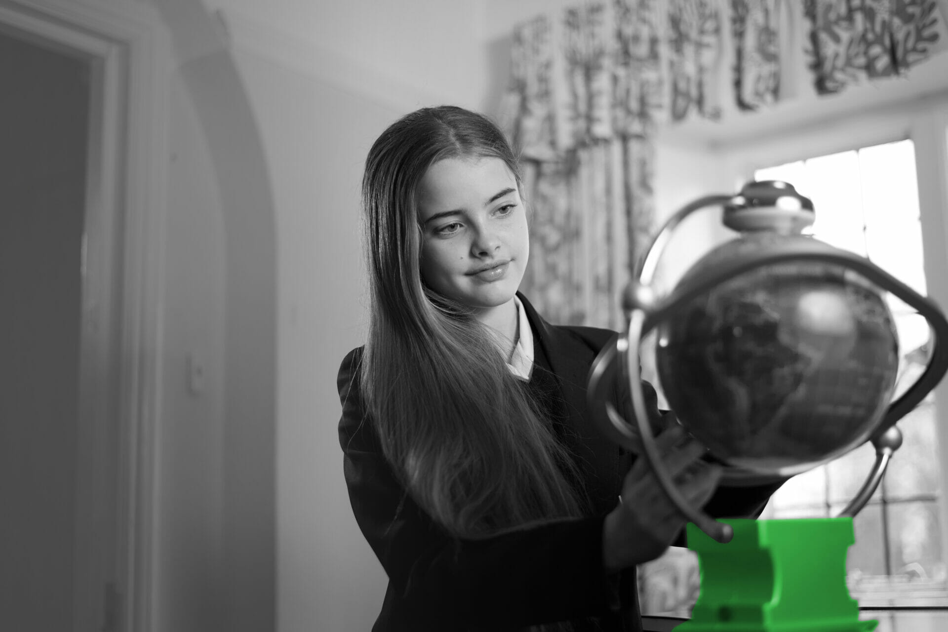 Student looking at a globe